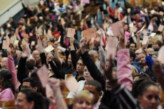UFT delegates vote with cards in the air.