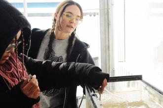 Students check aquarium temperature