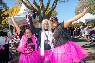 Three UFT members wearing black and pink shirts pose for a photo at a Making Strides Walk in Queens on Oct. 20, 2024