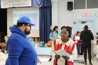 Toyin Akinrujomu (right), a parent at PS 22 on Staten Island, speaks with UFT Special Education Liaison Raphael Tomkin at the UFT Staten Island Family Partnership Summit on Nov. 9. 