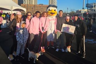 UFT members from Queens take a photo with the Brooklyn Cyclones mascot at a breast cancer walk in Coney Island. 