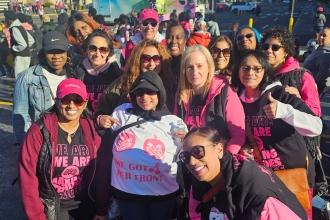 A group of UFT members at a Bronx breast cancer walk gather for a photo. 