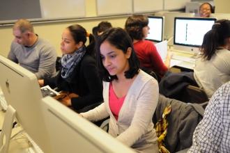 Woman sitting at a computer downloading UFT forms