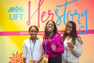 A woman takes a photo with her daughters at the UFT HERstory brunch on March 15, 2025. 