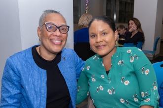 Two co-workers take a photo during their conversation at the 2025 UFT School Nurses Appreciation Dinner on May 7 at UFT headquarters. 