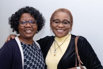 Two school nurses meet for a photo at the 2025 UFT School Nurse Appreciation Dinner on May 7 at UFT headquarters. 